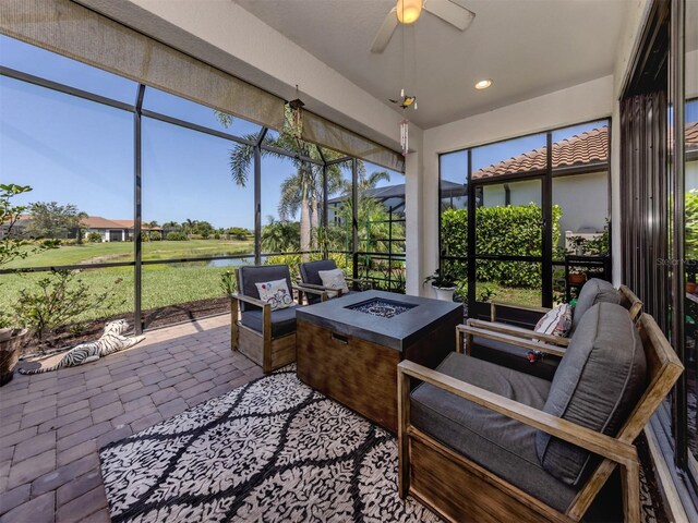 5853 Semolino St, Nokomis, FL 34275 - sunroom / solarium with a fire pit, a water view, and a ceiling fan