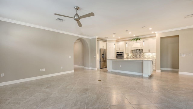 1481 Hyssop Loop, North Port, FL 34289 - unfurnished living room featuring a ceiling fan, crown molding, arched walkways, baseboards, and recessed lighting