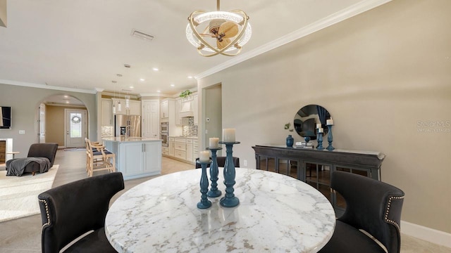 1481 Hyssop Loop, North Port, FL 34289 - dining area with arched walkways, ornamental molding, recessed lighting, and baseboards