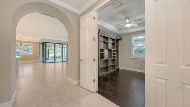 1481 Hyssop Loop, North Port, FL 34289 - hall with arched walkways, baseboards, crown molding, and a tray ceiling