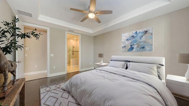 1481 Hyssop Loop, North Port, FL 34289 - bedroom featuring a raised ceiling, crown molding, wood finished floors, baseboards, and ensuite bathroom