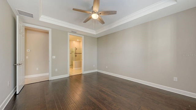 1481 Hyssop Loop, North Port, FL 34289 - unfurnished bedroom with a tray ceiling, ornamental molding, dark wood-type flooring, baseboards, and ensuite bath