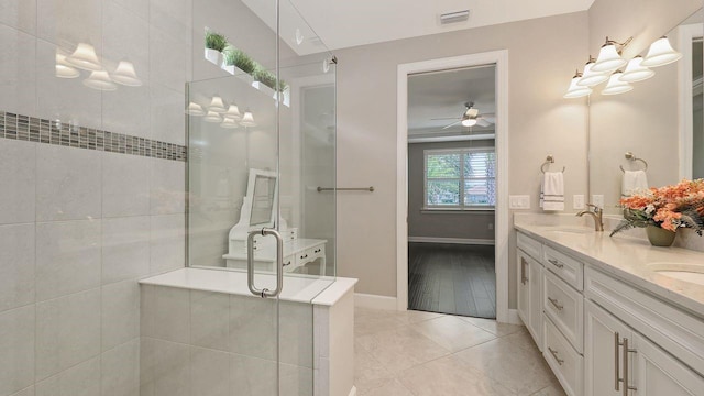 1481 Hyssop Loop, North Port, FL 34289 - full bathroom with double vanity, a tile shower, baseboards, ceiling fan, and tile patterned floors