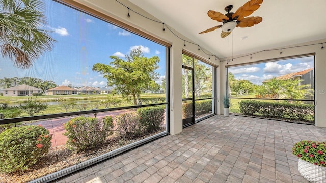 1481 Hyssop Loop, North Port, FL 34289 - unfurnished sunroom with a water view, a ceiling fan, lofted ceiling, brick patterned floors, and a residential view
