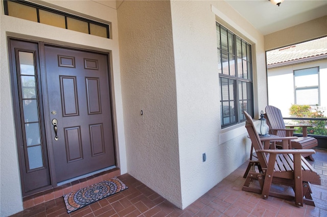 1438 Maseno Dr, Venice, FL 34292 - view of exterior entry featuring stucco siding and covered porch