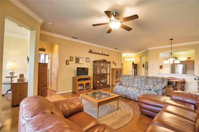 1438 Maseno Dr, Venice, FL 34292 - living area with a ceiling fan, wood finished floors, crown molding, and baseboards