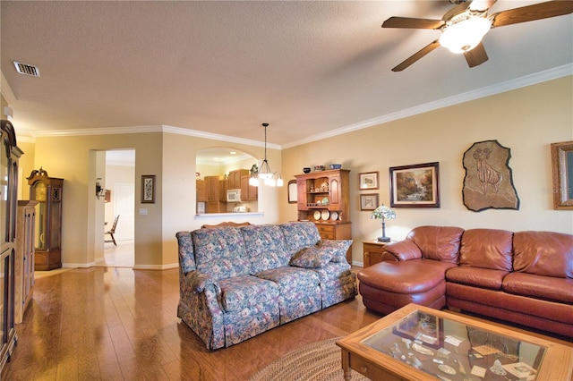 1438 Maseno Dr, Venice, FL 34292 - living area featuring light wood-type flooring, baseboards, a ceiling fan, crown molding, and a textured ceiling
