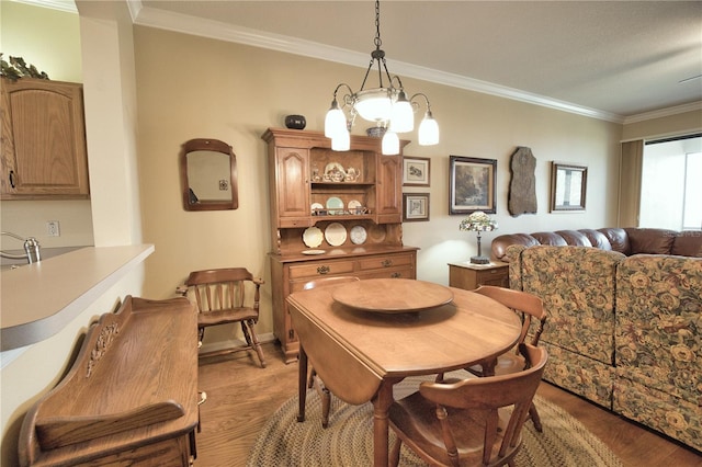 1438 Maseno Dr, Venice, FL 34292 - dining space with light wood-style flooring and crown molding