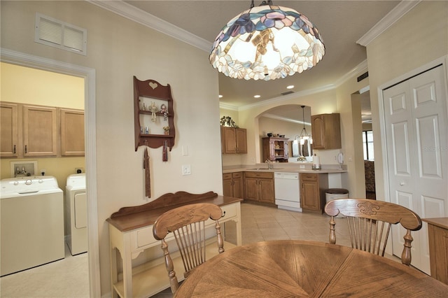 1438 Maseno Dr, Venice, FL 34292 - dining room featuring washer and dryer, a chandelier, crown molding, light tile patterned flooring, and arched walkways