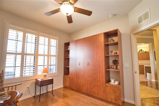 1438 Maseno Dr, Venice, FL 34292 - sitting room featuring light wood-type flooring, built in features, baseboards, and a ceiling fan