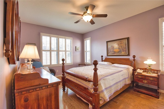 1438 Maseno Dr, Venice, FL 34292 - bedroom featuring wood finished floors, baseboards, and a ceiling fan