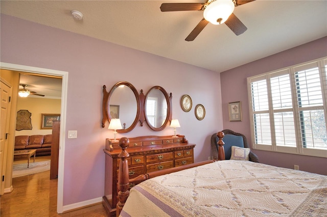 1438 Maseno Dr, Venice, FL 34292 - bedroom with light wood-type flooring, baseboards, and a ceiling fan