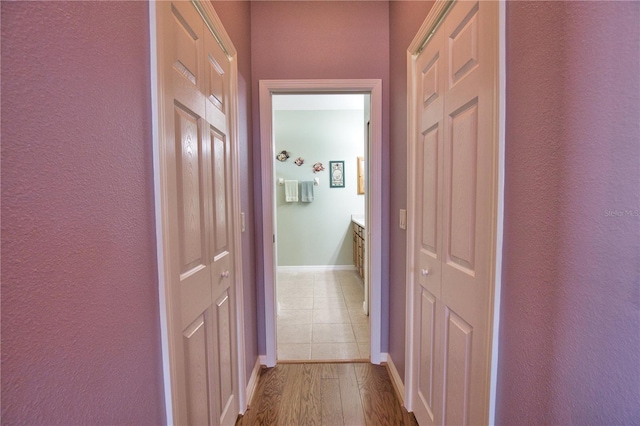 1438 Maseno Dr, Venice, FL 34292 - hallway featuring baseboards, wood finished floors, and a textured wall