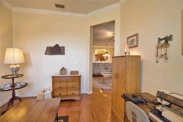 1438 Maseno Dr, Venice, FL 34292 - living area with wood finished floors, ornamental molding, a chandelier, and baseboards