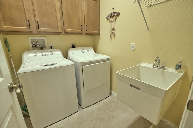 1438 Maseno Dr, Venice, FL 34292 - laundry room with washer and dryer, cabinet space, light tile patterned flooring, and baseboards
