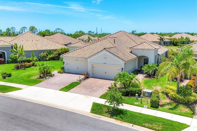 21649 Avon Park Ct, Venice, FL 34293 - mediterranean / spanish-style house featuring driveway, stucco siding, a front lawn, a tile roof, and a garage