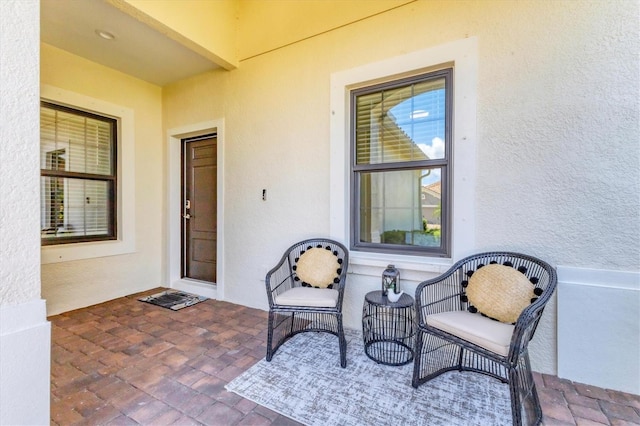 21649 Avon Park Ct, Venice, FL 34293 - view of exterior entry featuring stucco siding and a patio