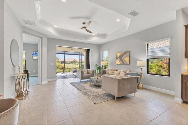 21649 Avon Park Ct, Venice, FL 34293 - living room with ceiling fan, a tray ceiling, baseboards, light tile patterned floors, and recessed lighting