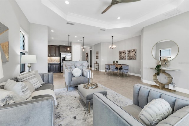 21649 Avon Park Ct, Venice, FL 34293 - living area with a tray ceiling, recessed lighting, a ceiling fan, a chandelier, and baseboards