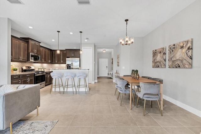 21649 Avon Park Ct, Venice, FL 34293 - dining area featuring light tile patterned floors, a chandelier, baseboards, and recessed lighting