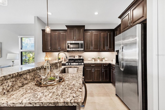 21649 Avon Park Ct, Venice, FL 34293 - kitchen with appliances with stainless steel finishes, dark brown cabinets, backsplash, and recessed lighting