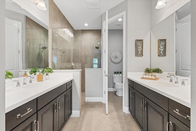 21649 Avon Park Ct, Venice, FL 34293 - bathroom featuring two vanities, toilet, walk in shower, and recessed lighting