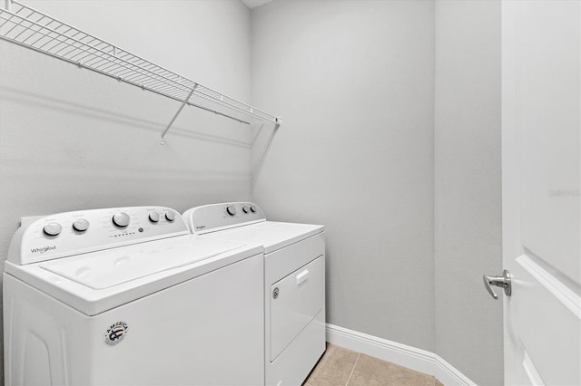 21649 Avon Park Ct, Venice, FL 34293 - laundry room with washer and dryer, light tile patterned flooring, and baseboards