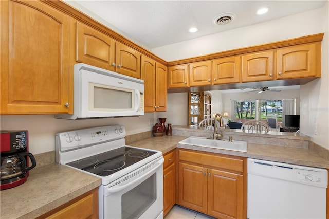 458 Cerromar Rd Unit 382, Venice, FL 34293 - kitchen with white appliances, a sink, light countertops, brown cabinetry, and recessed lighting