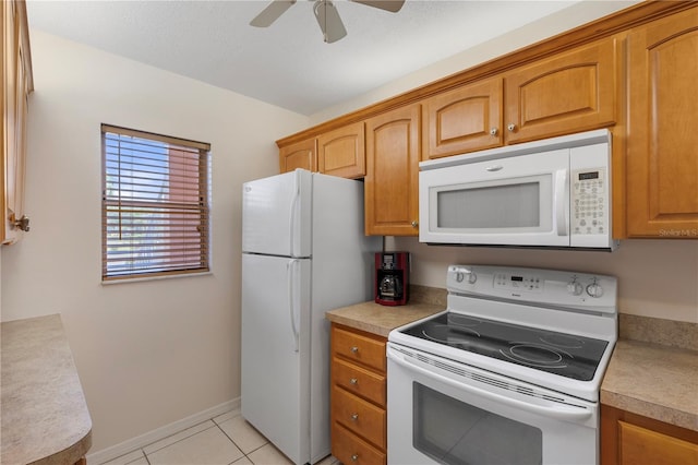 458 Cerromar Rd Unit 382, Venice, FL 34293 - kitchen with white appliances, a ceiling fan, light tile patterned flooring, light countertops, and brown cabinetry