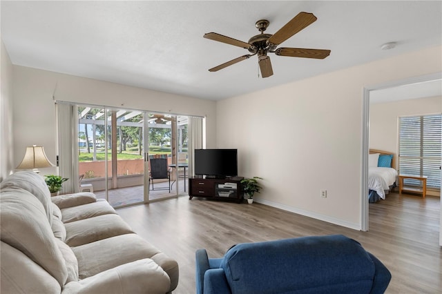458 Cerromar Rd Unit 382, Venice, FL 34293 - living area with ceiling fan, wood finished floors, and baseboards