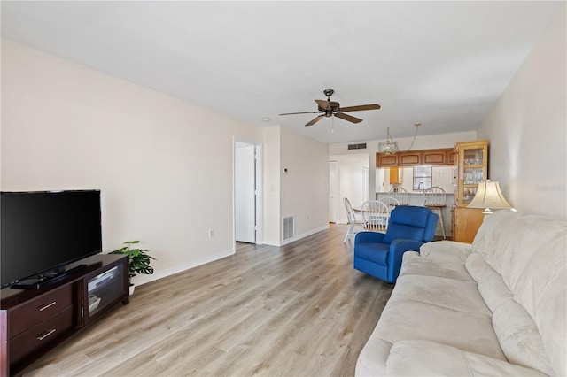 458 Cerromar Rd Unit 382, Venice, FL 34293 - living area with ceiling fan, light wood-style flooring, and baseboards