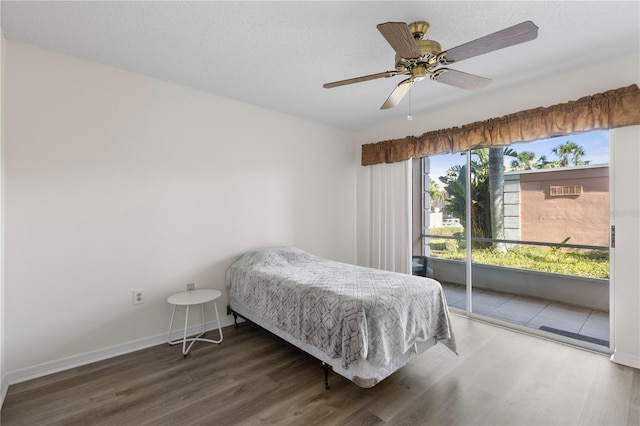 458 Cerromar Rd Unit 382, Venice, FL 34293 - bedroom with access to outside, wood finished floors, a ceiling fan, and baseboards