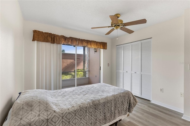 458 Cerromar Rd Unit 382, Venice, FL 34293 - bedroom featuring wood finished floors, a closet, baseboards, and ceiling fan