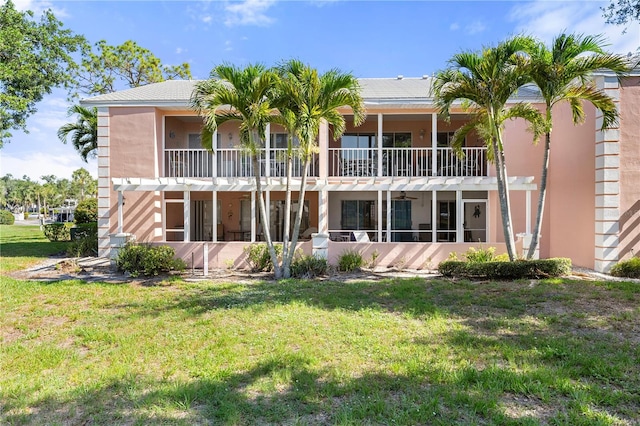 458 Cerromar Rd Unit 382, Venice, FL 34293 - rear view of house with a lawn, stucco siding, a pergola, and a balcony
