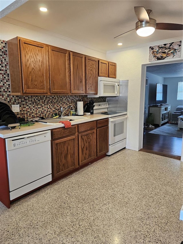 1103 Lucille Ave, Nokomis, FL 34275 - kitchen with white appliances, decorative backsplash, light countertops, ceiling fan, and crown molding