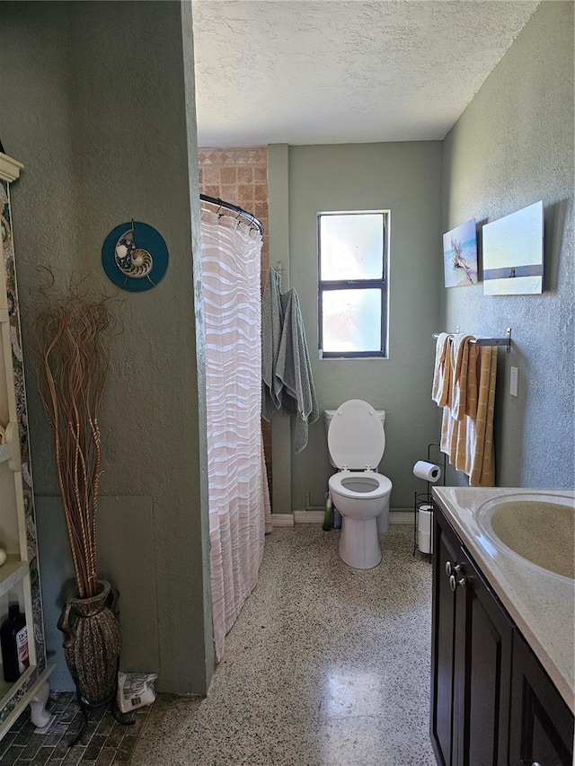 1103 Lucille Ave, Nokomis, FL 34275 - full bathroom with toilet, a textured wall, a textured ceiling, vanity, and speckled floor
