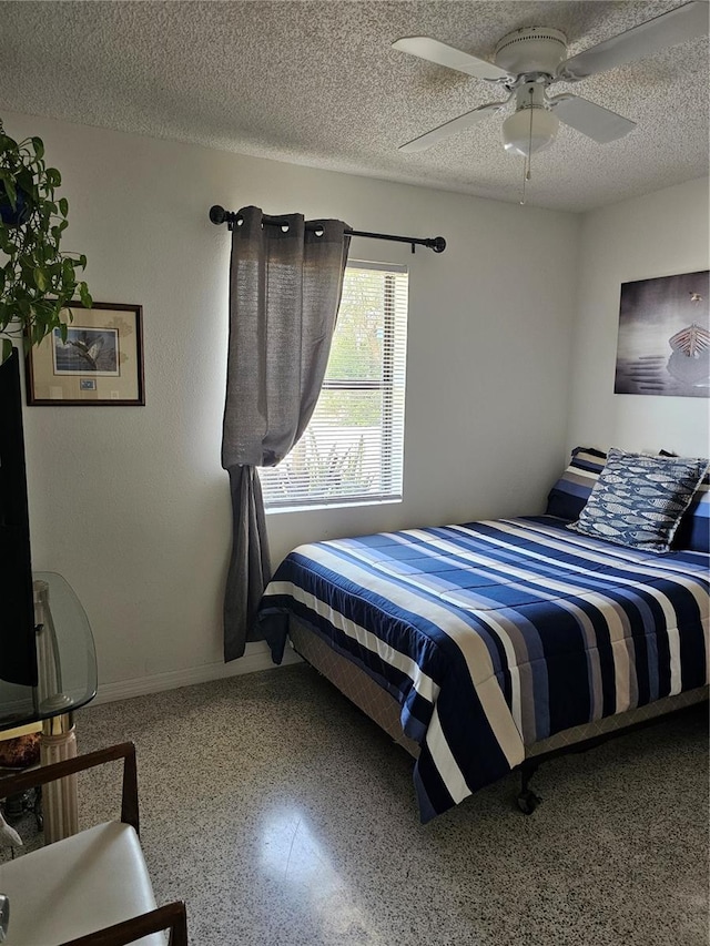 1103 Lucille Ave, Nokomis, FL 34275 - bedroom with speckled floor, a textured ceiling, baseboards, and ceiling fan