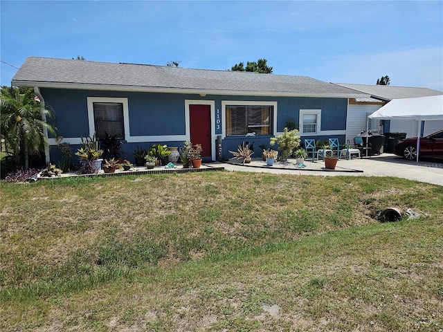 1103 Lucille Ave, Nokomis, FL 34275 - view of front facade with a front lawn, roof with shingles, and stucco siding