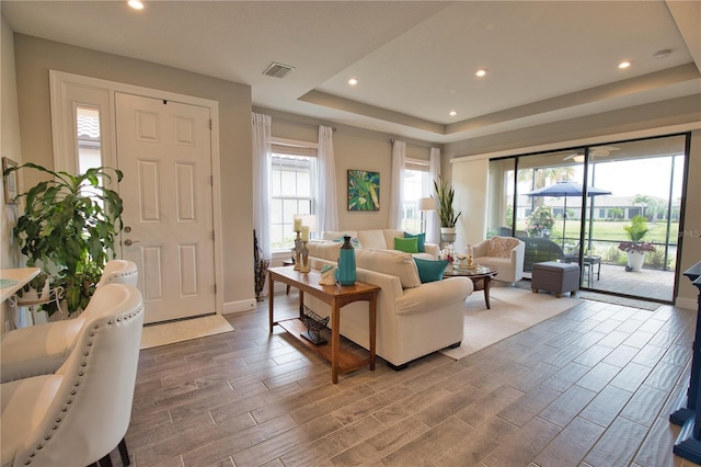 10410 Inglenook Ter, Palmetto, FL 34221 - living room with a tray ceiling, wood finished floors, recessed lighting, and baseboards