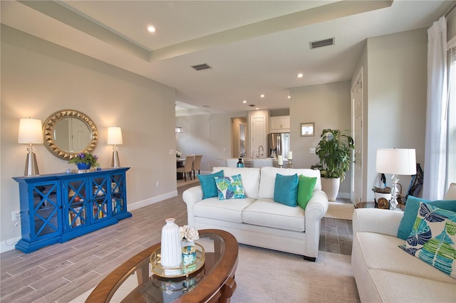 10410 Inglenook Ter, Palmetto, FL 34221 - living room featuring baseboards, light wood finished floors, recessed lighting, and a raised ceiling