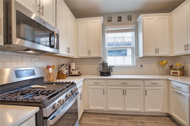 10410 Inglenook Ter, Palmetto, FL 34221 - kitchen with appliances with stainless steel finishes, white cabinets, light countertops, and tasteful backsplash