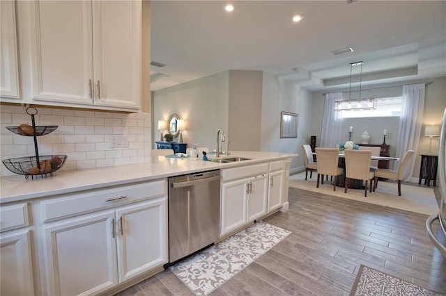10410 Inglenook Ter, Palmetto, FL 34221 - kitchen featuring dishwasher, a sink, white cabinets, decorative backsplash, and recessed lighting