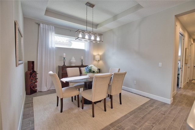 10410 Inglenook Ter, Palmetto, FL 34221 - dining room featuring wood finished floors, baseboards, and a raised ceiling