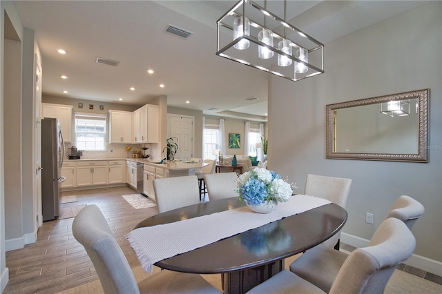 10410 Inglenook Ter, Palmetto, FL 34221 - dining area featuring baseboards, light wood finished floors, recessed lighting, and a chandelier