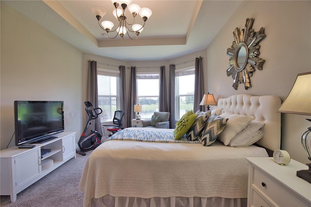 10410 Inglenook Ter, Palmetto, FL 34221 - bedroom with light carpet, a raised ceiling, and a chandelier