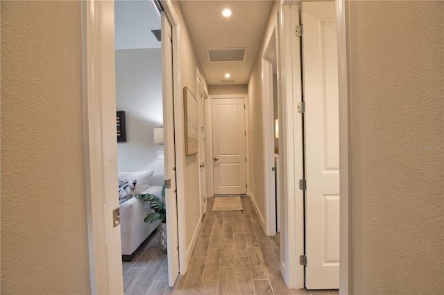 10410 Inglenook Ter, Palmetto, FL 34221 - corridor featuring wood finished floors, a textured wall, and recessed lighting