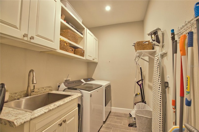10410 Inglenook Ter, Palmetto, FL 34221 - laundry room with washer and dryer, cabinet space, baseboards, and wood finish floors