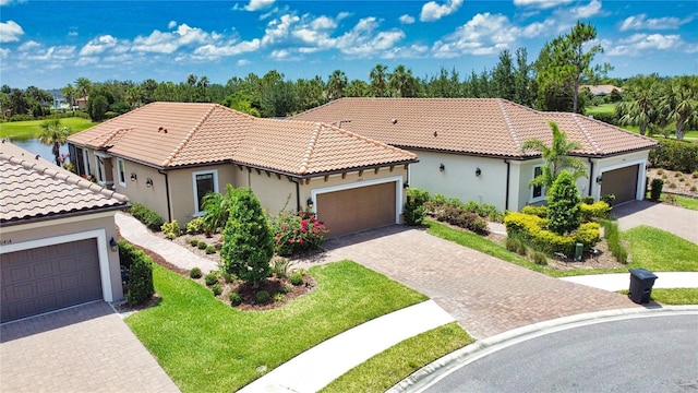 10410 Inglenook Ter, Palmetto, FL 34221 - mediterranean / spanish house with stucco siding, a tiled roof, driveway, and a front yard