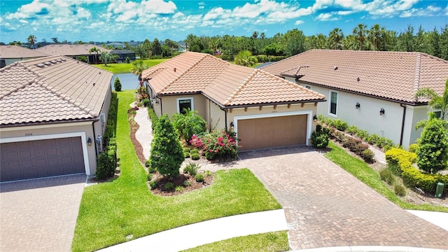 10410 Inglenook Ter, Palmetto, FL 34221 - mediterranean / spanish home with a front yard, a tile roof, driveway, and stucco siding