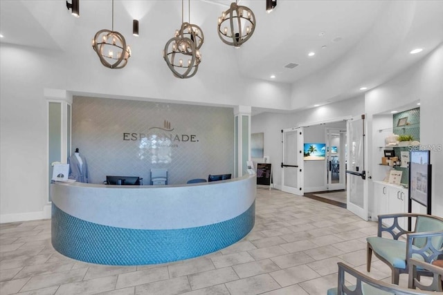 10410 Inglenook Ter, Palmetto, FL 34221 - reception area with recessed lighting, a chandelier, and a high ceiling